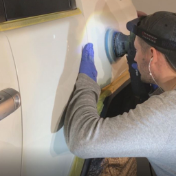 Auto detailing expert compounding exterior with rotary buffer